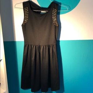 Black babydoll dress with gold stud accents